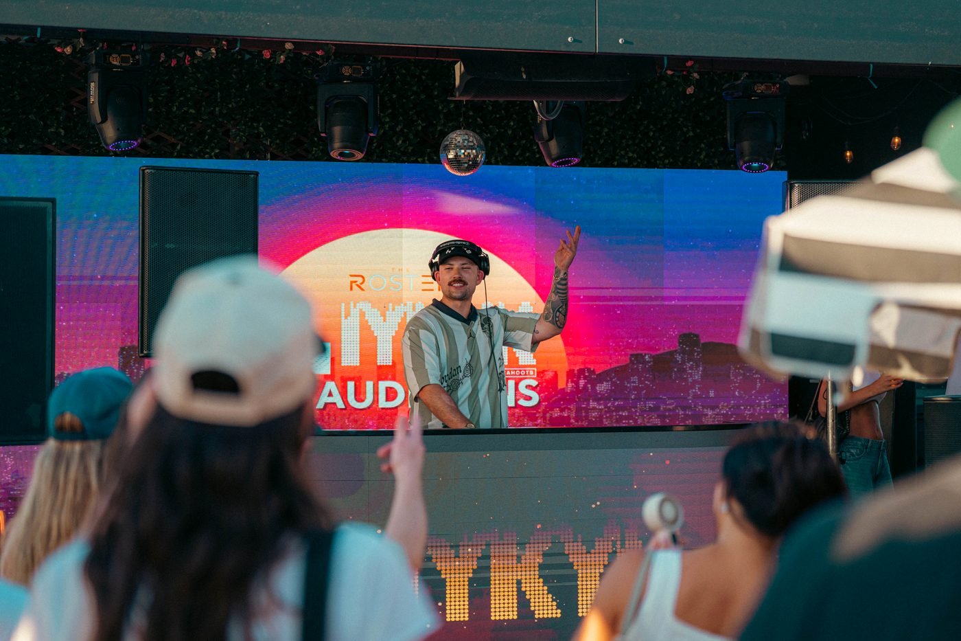 B.Y. throwing a peace sign at the crowd mid-set.